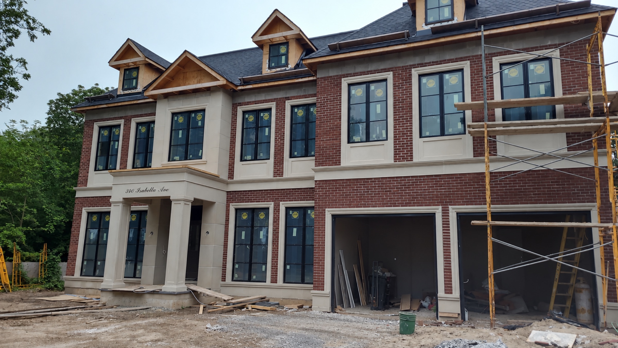 A brick and stone custom home under construction at 340 Isabella Avenue